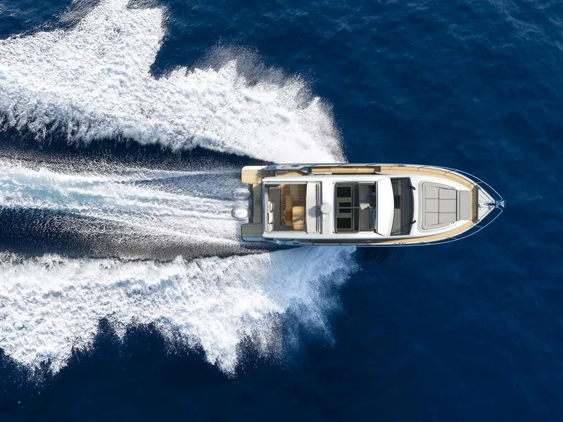 Slide: The Image of Aerial view of 2026 Sealine C390 yacht cruising on open blue water. - 14