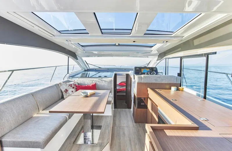 Slide: The Image of Luxurious interior of 2026 Sealine C390 yacht with panoramic windows and modern furnishings. - 16