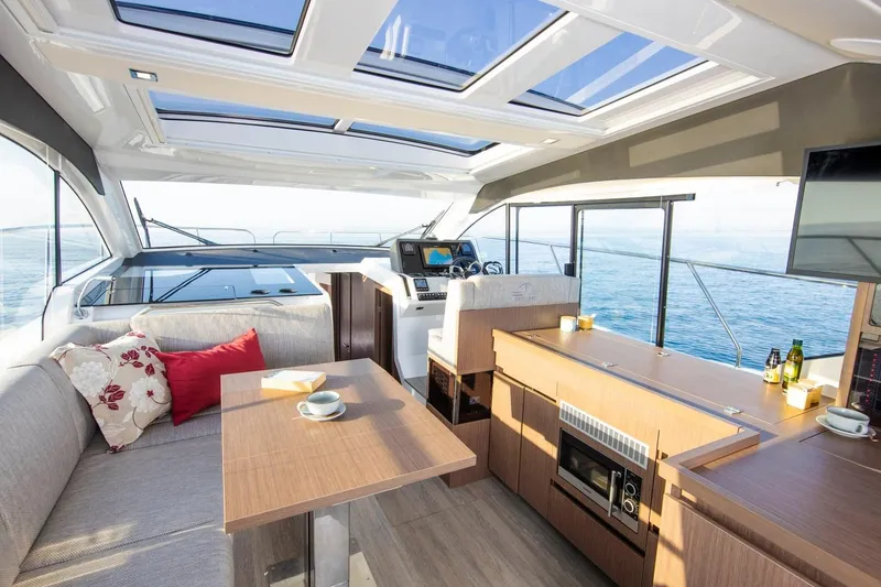 Slide: The Image of 2026 Sealine C390 yacht interior with modern seating, dining area, and ocean view. - 17