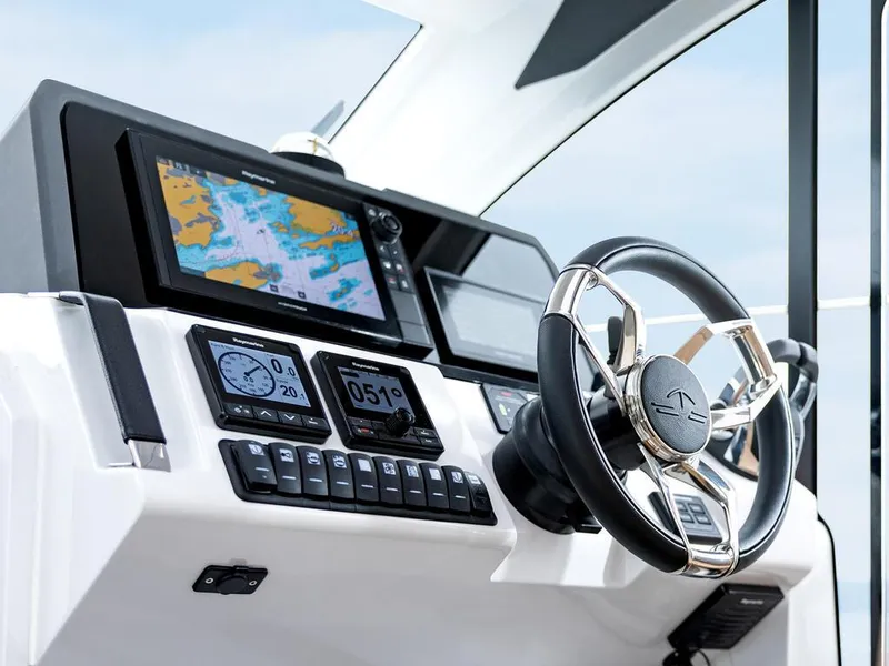 Slide: The Image of 2026 Sealine C390 helm with modern navigation system and sleek steering wheel. - 22