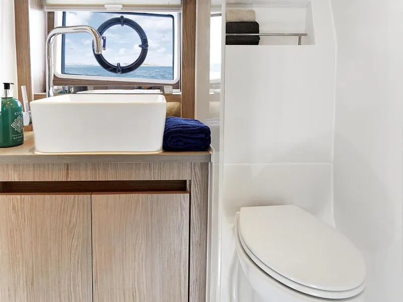 Slide: The Image of Modern bathroom in 2026 Sealine C390 yacht with sink, toilet, and ocean view. - 32
