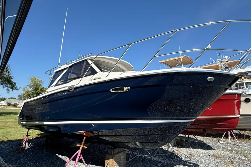 The Image of 2026 Cutwater C-248 Coupe boat on display under clear blue sky. - 1