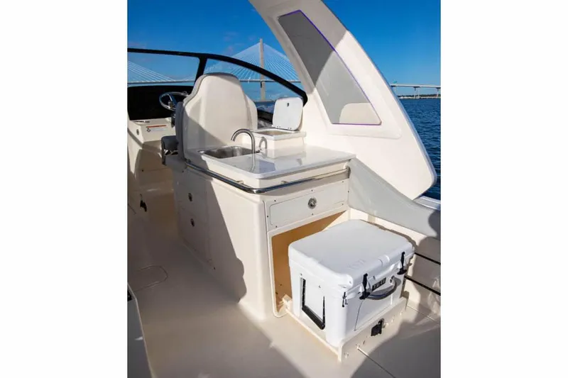 Slide: The Image of Manufacturer Provided Image: 2025 Scout 277 Dorado boat interior with sink and cooler, featuring sleek design. - 11