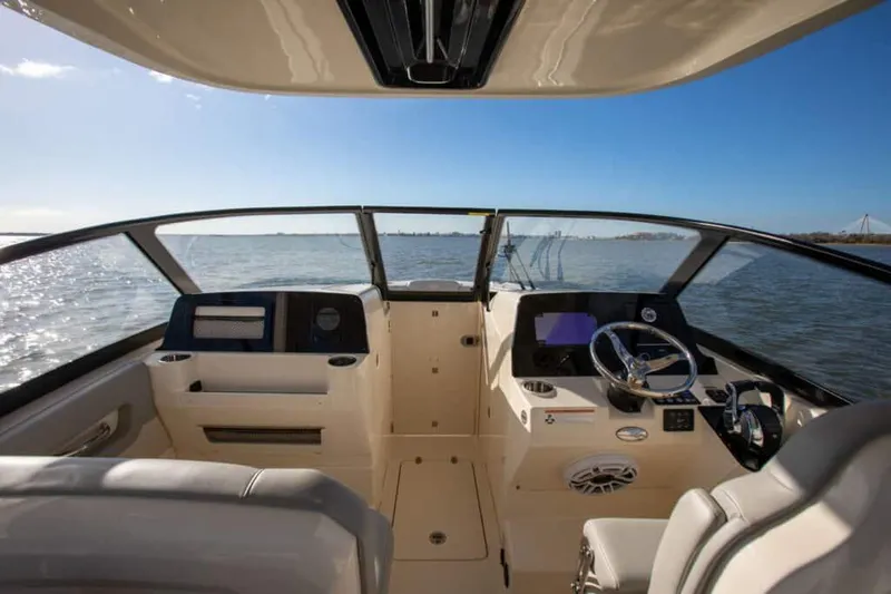 Slide: The Image of Manufacturer Provided Image: 2025 Scout 277 Dorado boat interior with ocean view and modern dashboard. - 6