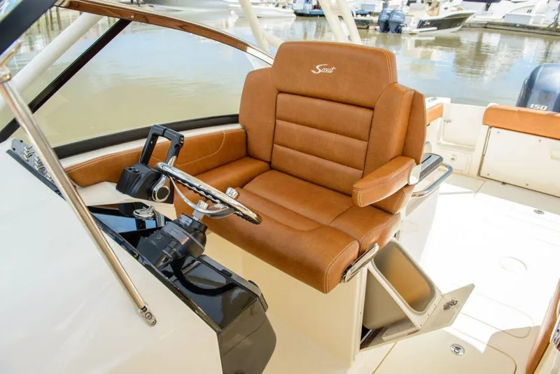 Slide: The Image of Manufacturer Provided Image: 2025 Scout 255 Dorado boat helm with luxurious brown leather seating. - 8