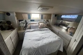 Slide: The Image of 1990 Hatteras 40 Motor Yacht bedroom with cozy bed and ample storage. - 10