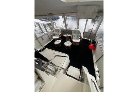 Slide: The Image of 1990 Hatteras 40 Motor Yacht interior with seating and water view. - 5