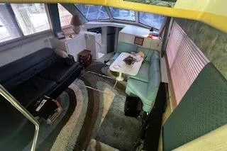 Slide: The Image of 1990 Hatteras 40 Motor Yacht interior with seating, table, and helm station. - 9