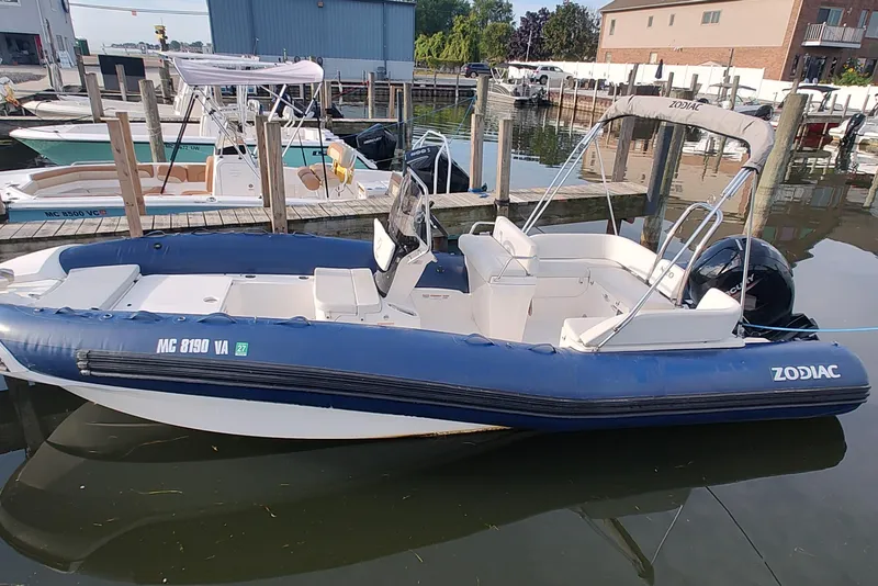 The Image of 2024 Zodiac N-ZO 680 boat docked at marina, featuring blue and white design. - 0