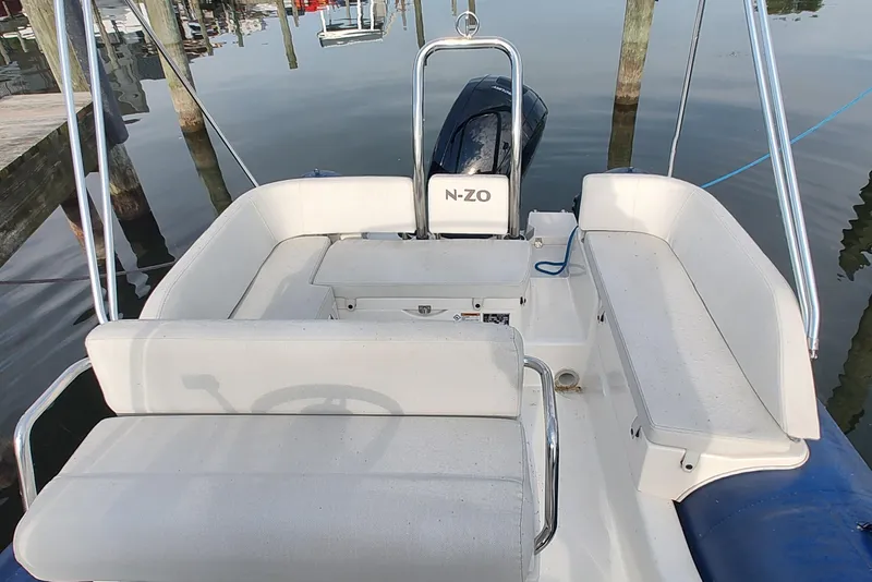 Slide: The Image of 2024 Zodiac N-ZO 680 boat interior with white seating and steering console. - 3