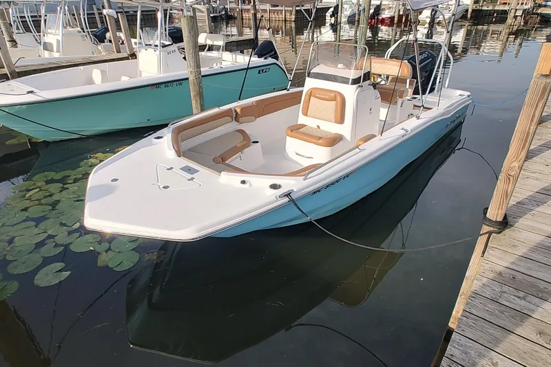 The Image of 2026 NauticStar 231 Hybrid boat docked, featuring sleek design and comfortable seating. - 0