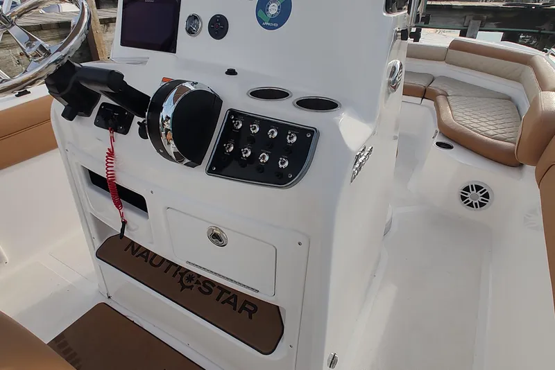 Slide: The Image of 2026 NauticStar 231 Hybrid boat interior with steering console and seating. - 13