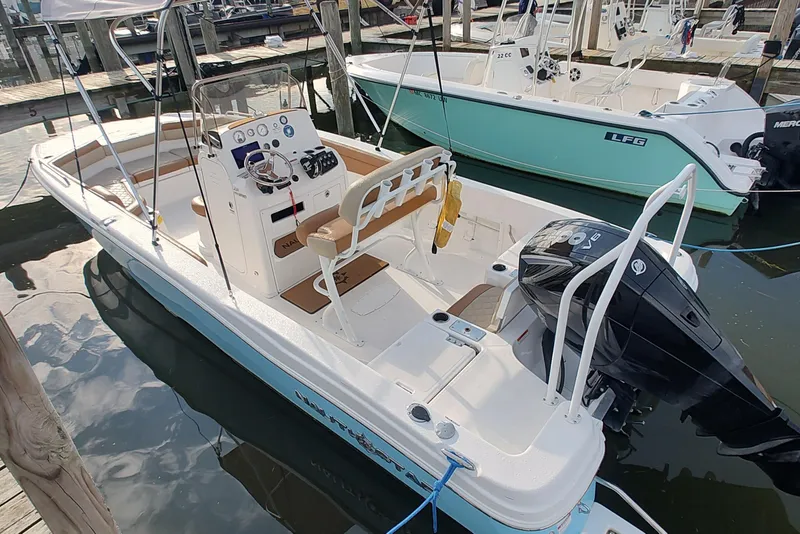 Slide: The Image of 2026 NauticStar 231 Hybrid boat docked, featuring sleek design and modern amenities. - 7