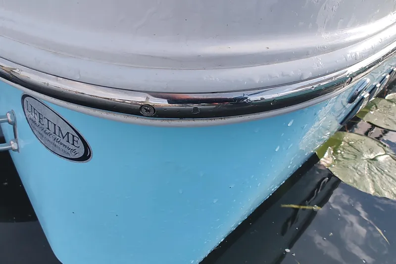 Slide: The Image of Close-up of 2026 NauticStar 231 Hybrid boat hull with lifetime warranty badge. - 8