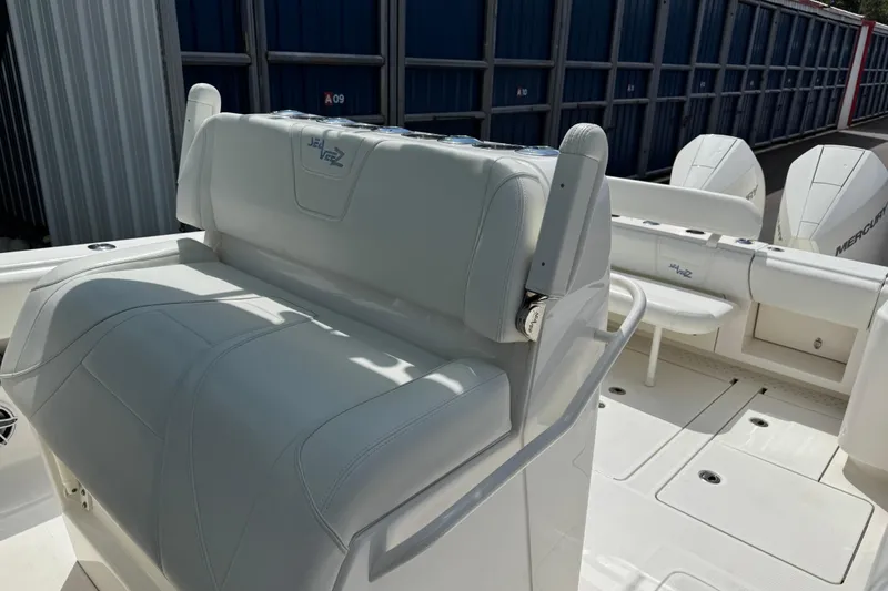 Slide: The Image of 2024 SeaVee 32Z boat interior with white seating and Mercury engines. - 10