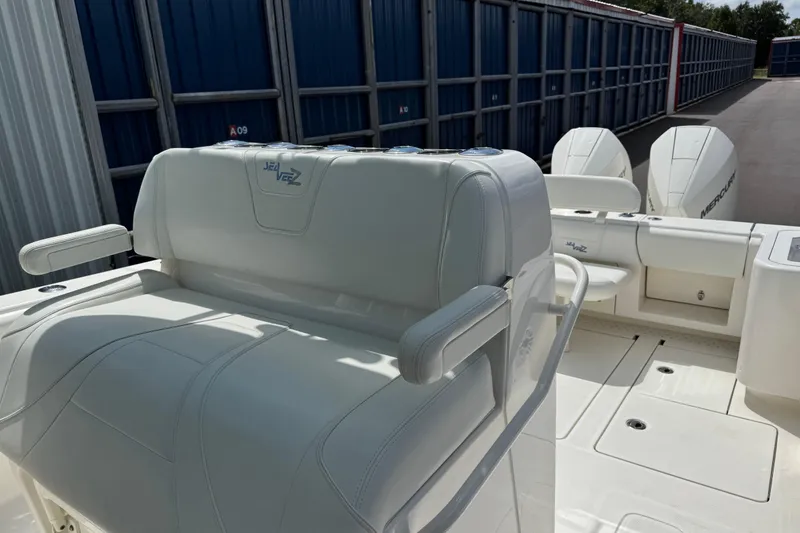 Slide: The Image of 2024 SeaVee 32Z boat interior with white seating and dual Mercury engines. - 11