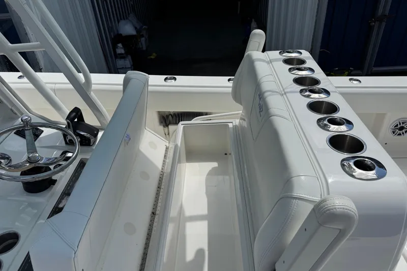 Slide: The Image of 2024 SeaVee 32Z boat interior with steering wheel and cup holders. - 12