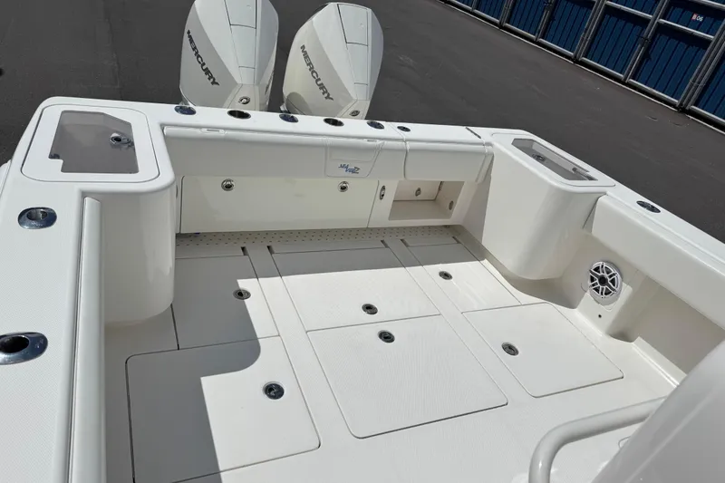 Slide: The Image of 2024 SeaVee 32Z boat deck with Mercury engines, spacious layout, and storage compartments. - 17
