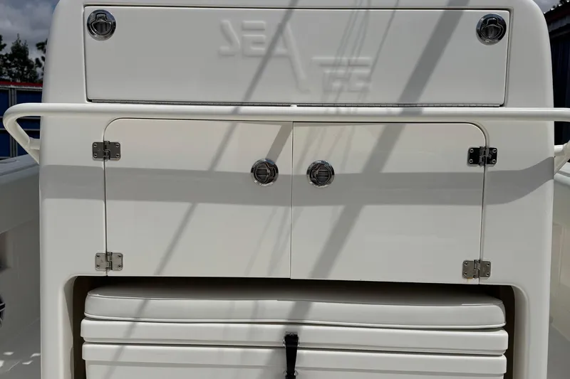 Slide: The Image of 2024 SeaVee 32Z boat storage compartment with sleek white finish and secure latches. - 19