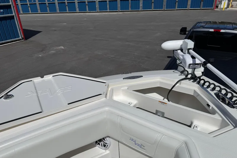 Slide: The Image of 2024 SeaVee 32Z boat bow with storage compartments and trolling motor. - 24