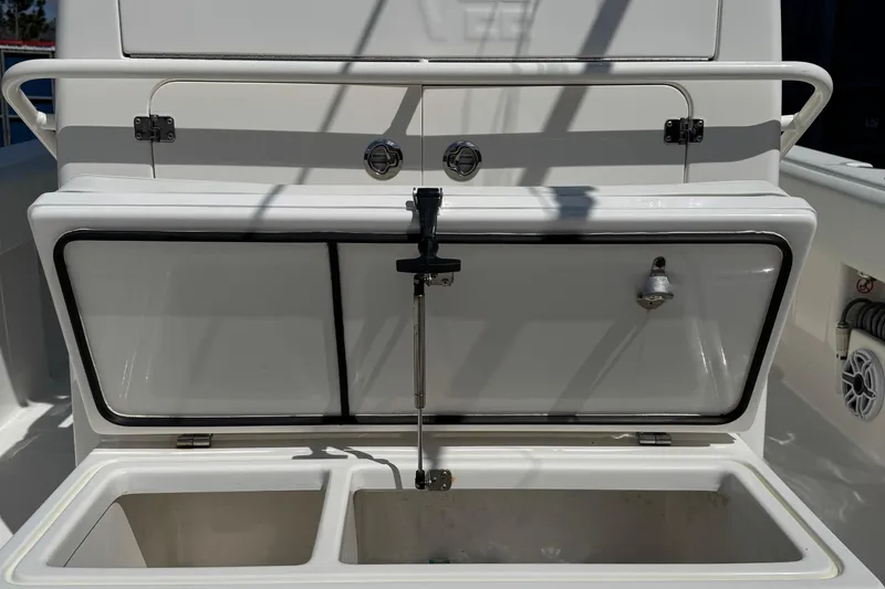 Slide: The Image of 2024 SeaVee 32Z boat storage compartment with open hatch and interior view. - 28