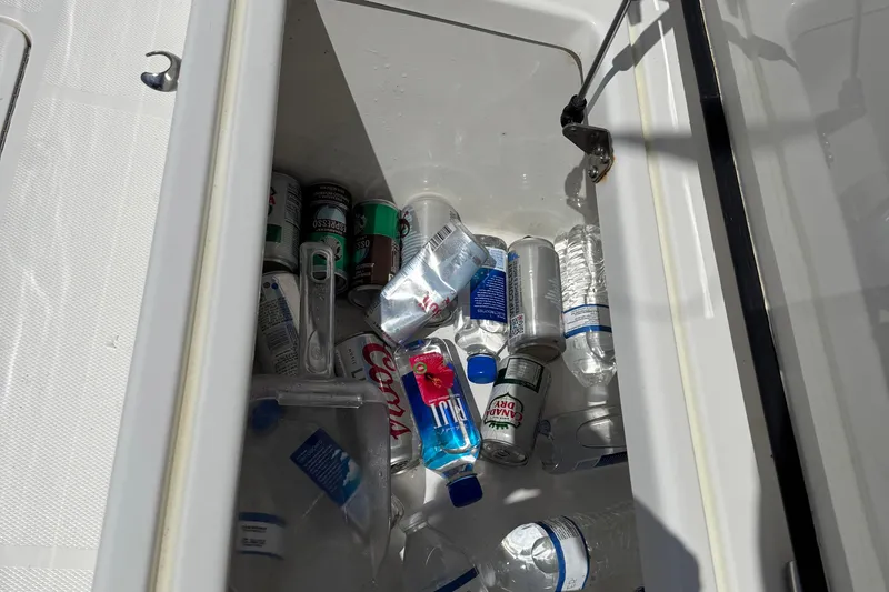 Slide: The Image of Cooler on 2024 SeaVee 32Z boat filled with drinks and water bottles. - 30