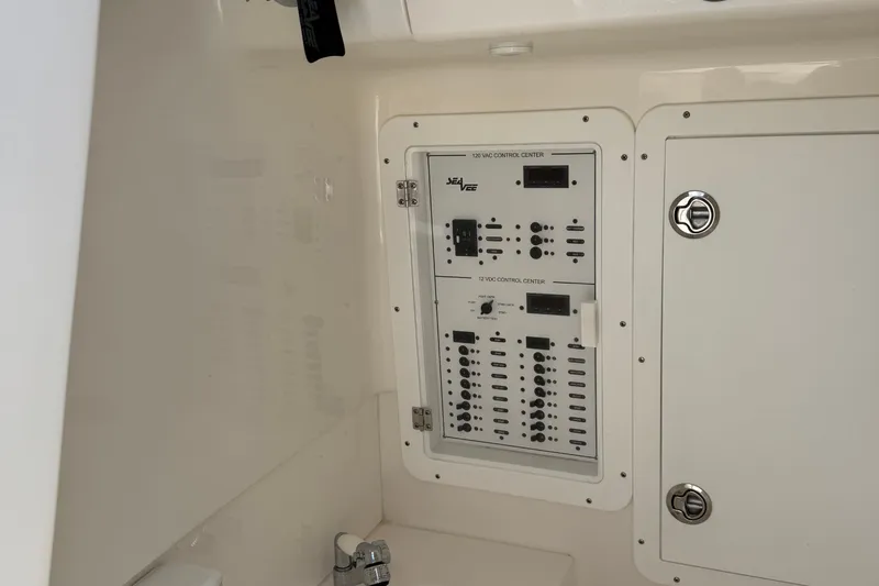 Slide: The Image of 2024 SeaVee 32Z control panel with switches and dials in a white interior. - 32