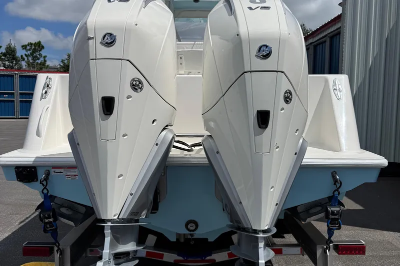 Slide: The Image of 2024 SeaVee 32Z boat with dual outboard engines on a trailer. - 4
