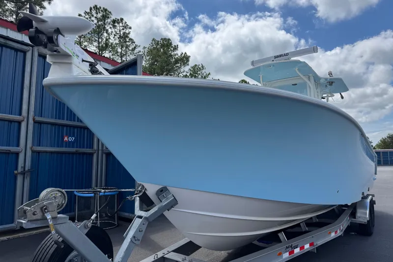 Slide: The Image of 2024 SeaVee 32Z boat on trailer, light blue hull, parked outdoors. - 5