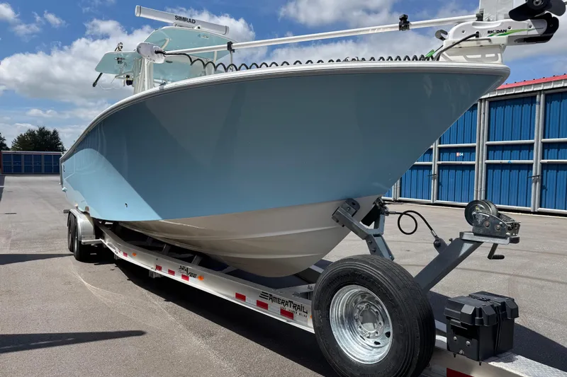 Slide: The Image of 2024 SeaVee 32Z boat on trailer, light blue hull, parked outdoors. - 6