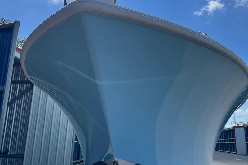 Slide: The Image of 2024 SeaVee 32Z boat hull, light blue, viewed from below against a clear sky. - 9