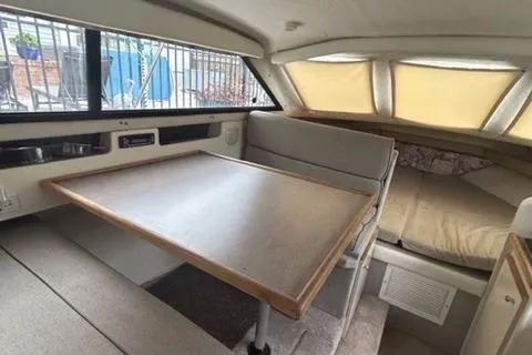 Slide: The Image of 1994 Bayliner 2859 Classic Cruiser interior with dining table and sleeping area. - 10