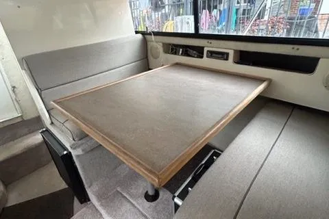Slide: The Image of 1994 Bayliner 2859 Classic Cruiser interior with dining table and seating area. - 12