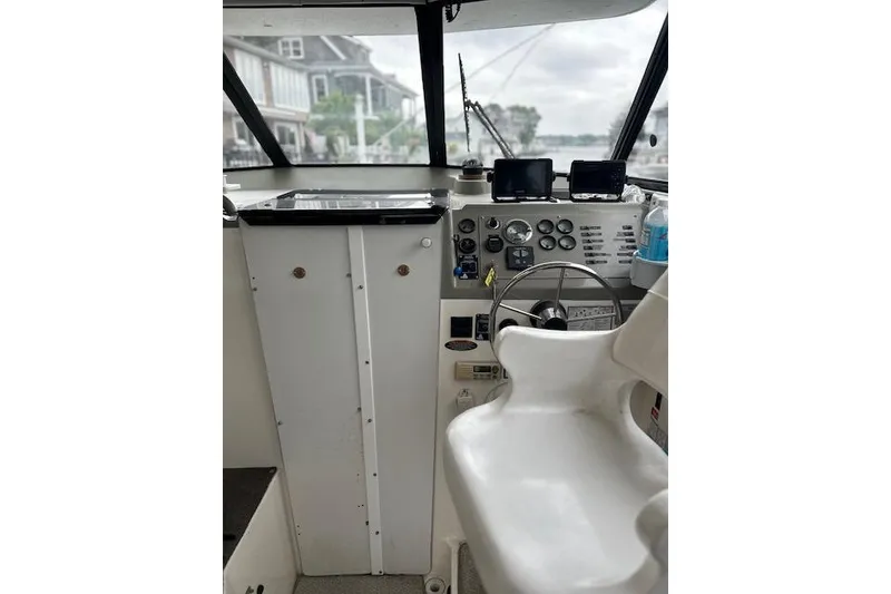 Slide: The Image of 1994 Bayliner 2859 Classic Cruiser helm with steering wheel and control panel. - 3