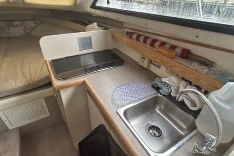 Slide: The Image of 1994 Bayliner 2859 Classic Cruiser interior with kitchenette and sink area. - 7