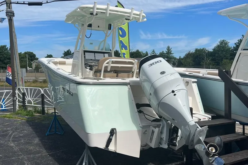 Slide: The Image of 2023 Sea Born SX239 Offshore boat displayed outdoors under a clear blue sky. - 2