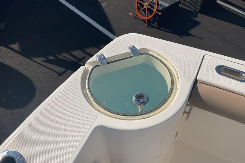 Slide: The Image of 2023 Sea Born SX239 Offshore boat with a circular livewell on deck. - 26