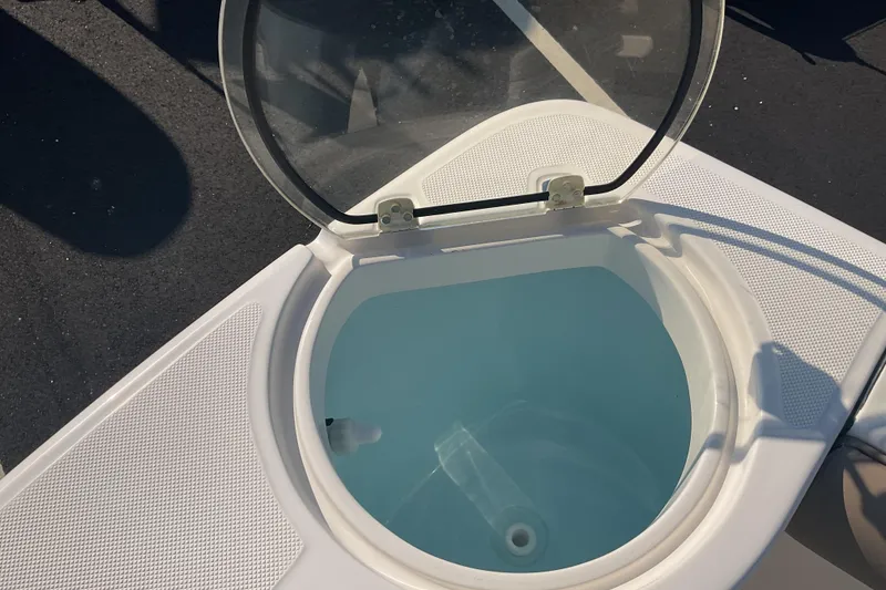 Slide: The Image of 2023 Sea Born SX239 Offshore boat livewell with open lid, showcasing interior design. - 27