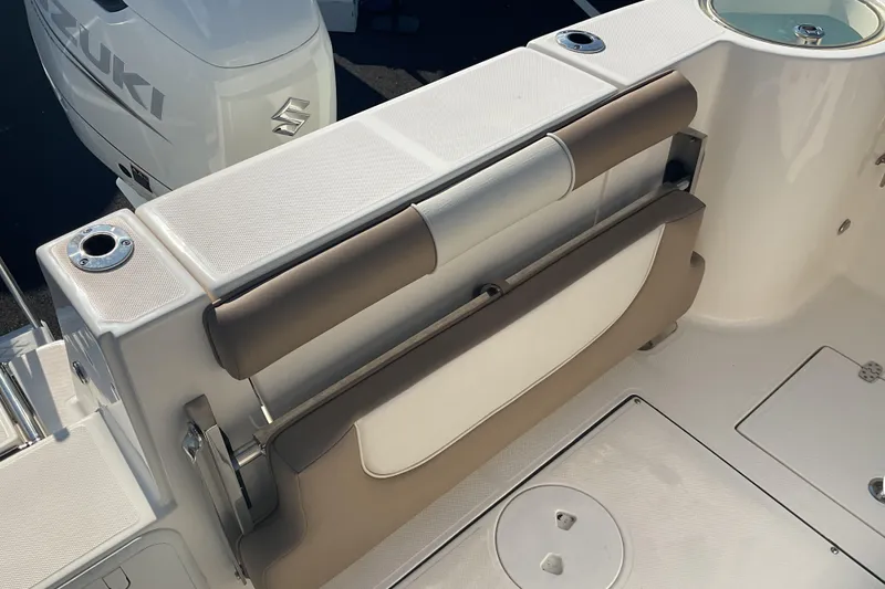 Slide: The Image of 2023 Sea Born SX239 Offshore boat interior with Suzuki engine, featuring seating and storage. - 28