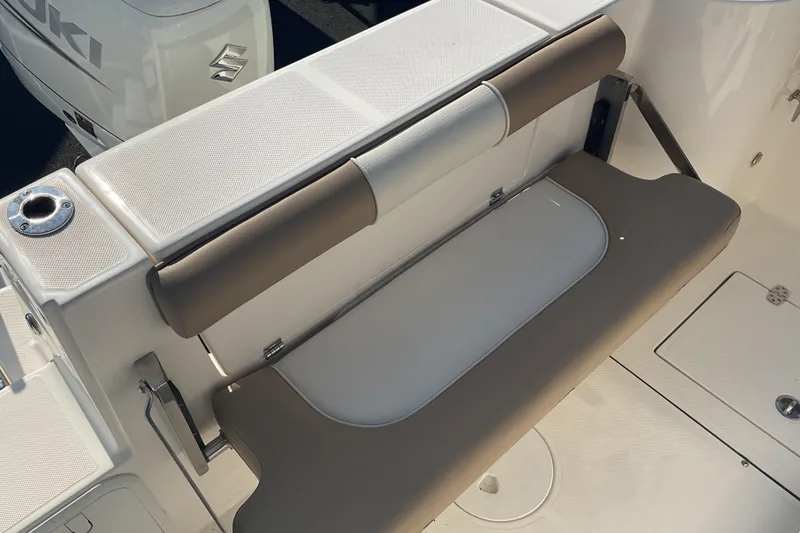 Slide: The Image of 2023 Sea Born SX239 Offshore boat seating area with Suzuki engine in background. - 29