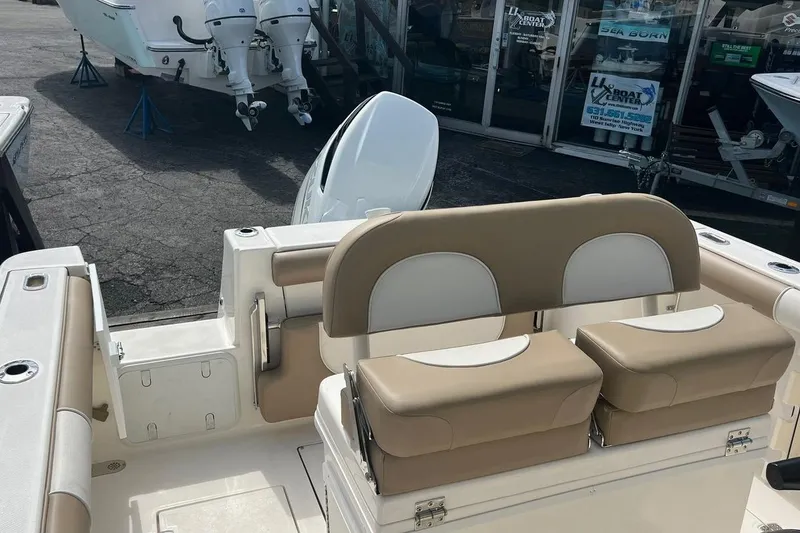 Slide: The Image of 2023 Sea Born SX239 Offshore boat dashboard with Simrad displays and steering wheel. - 4