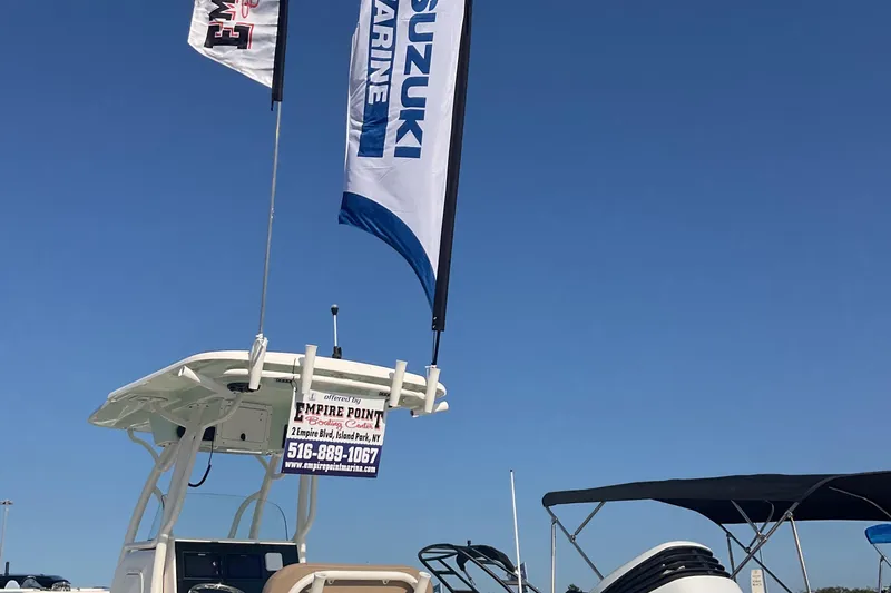 Slide: The Image of 2023 Sea Born SX239 Offshore boat with Suzuki Marine flags under clear blue sky. - 43