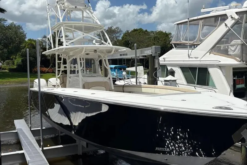 The Image of 2017 Jupiter 38 FS boat docked, featuring sleek design and spacious deck. - 1