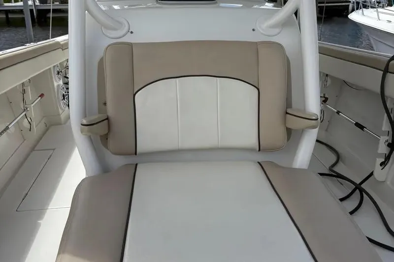 Slide: The Image of 2017 Jupiter 38 FS boat interior with beige and white cushioned seating. - 18
