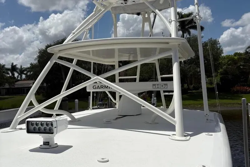 Slide: The Image of 2017 Jupiter 38 FS boat with Garmin xHD2 radar and spotlight, under a clear sky. - 2