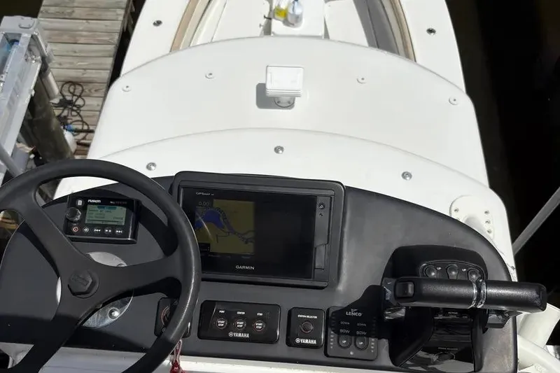 Slide: The Image of 2017 Jupiter 38 FS boat helm with Garmin navigation and Yamaha controls. - 21