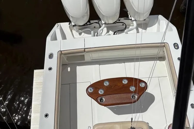 Slide: The Image of 2017 Jupiter 38 FS boat deck with triple engines and wooden table. - 30