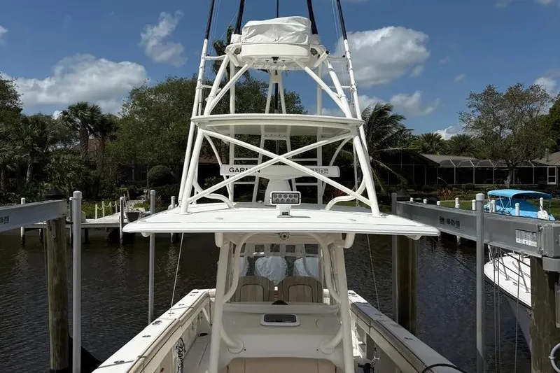 Slide: The Image of 2017 Jupiter 38 FS boat docked, featuring a tower and spacious deck. - 32