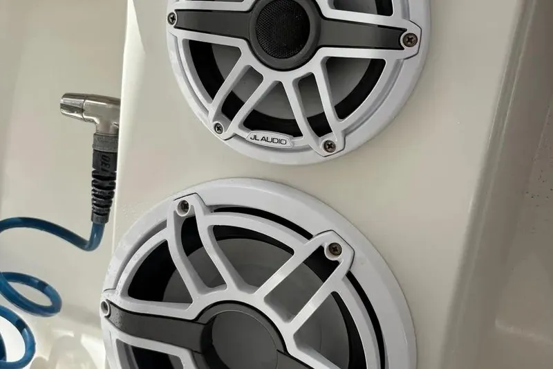 Slide: The Image of Speakers on a 2017 Jupiter 38 FS boat with JL Audio branding and coiled blue cable. - 38