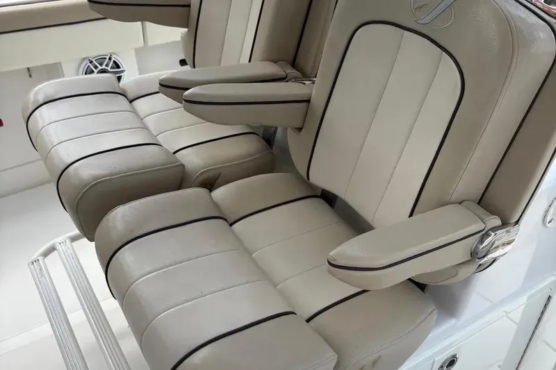 Slide: The Image of Luxurious seating on a 2017 Jupiter 38 FS boat, featuring beige upholstery and armrests. - 6